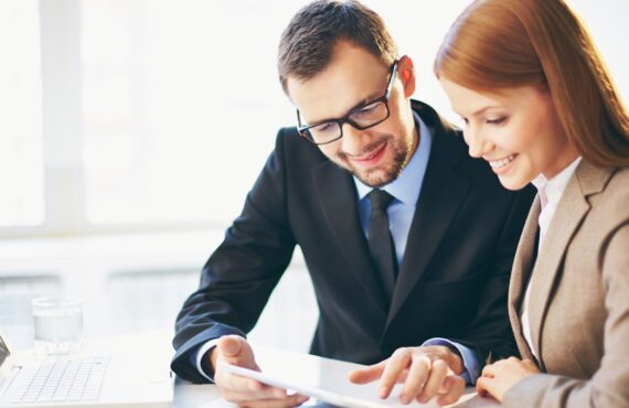 Young businessman explaining ideas to his colleague at meeting